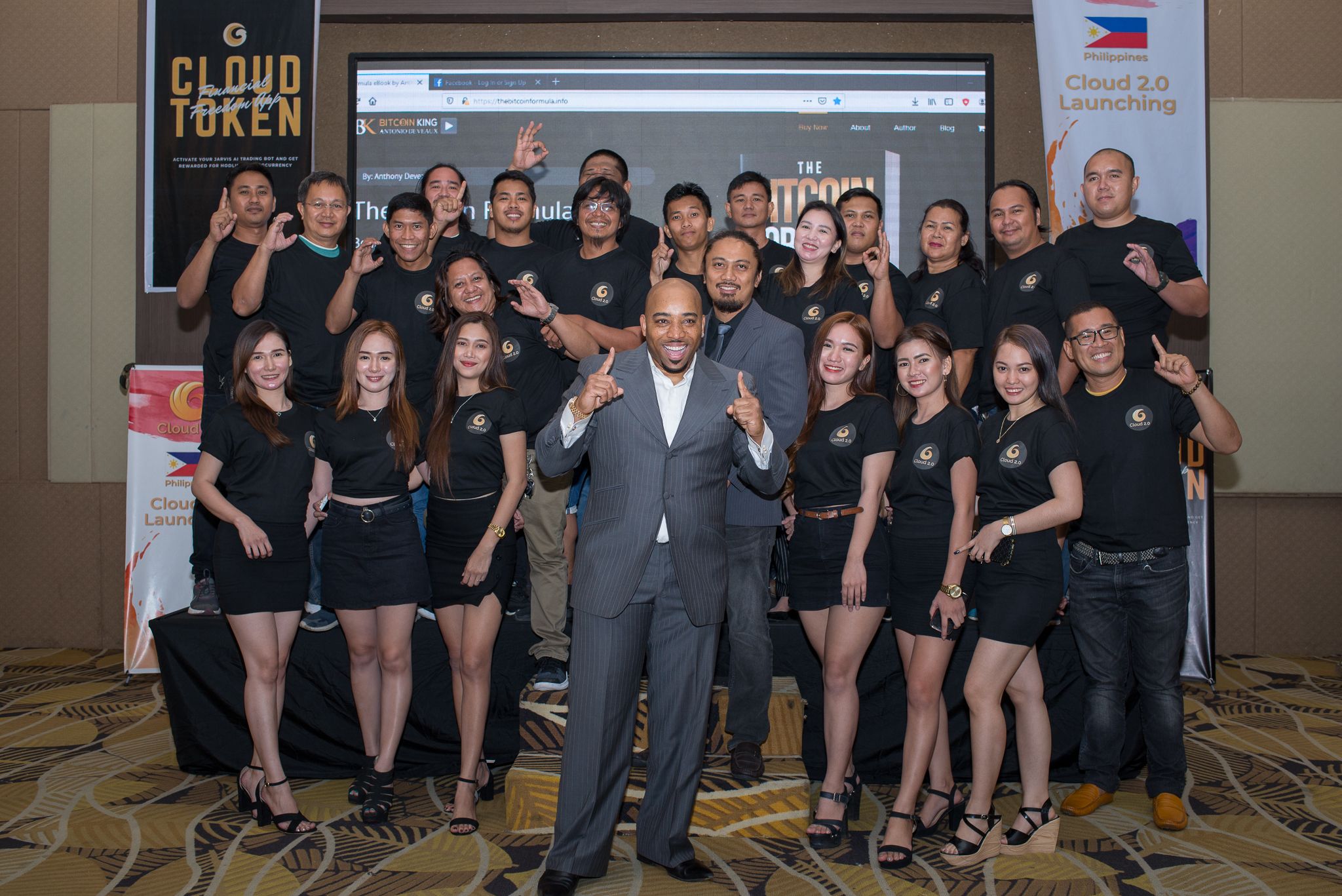 Anthony on stage with a large group